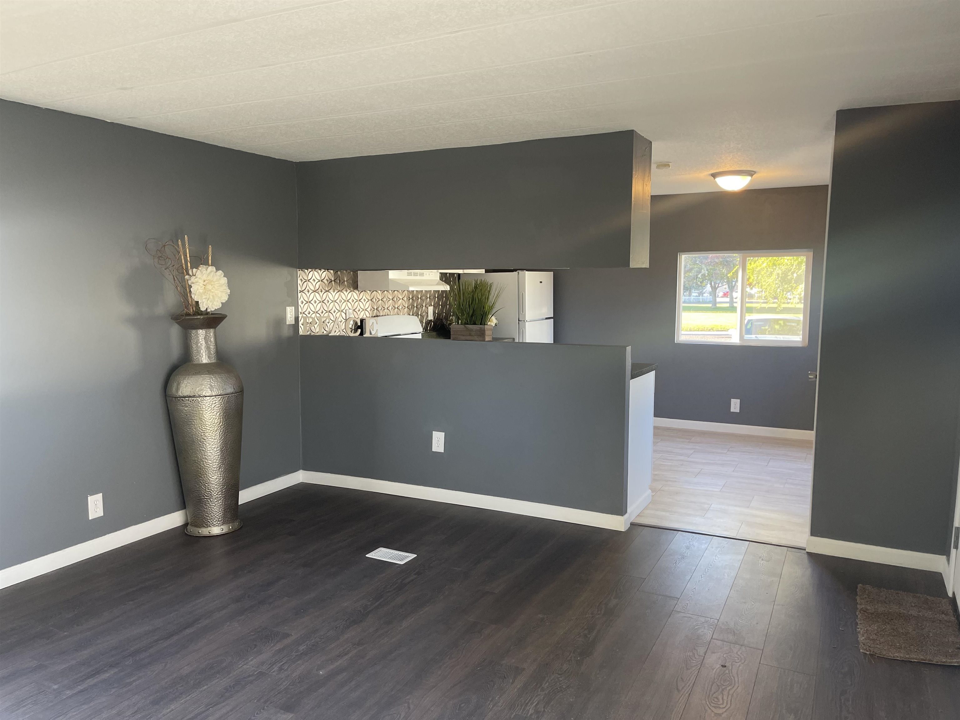 420 Pisces Circle Fruita, CO 81521 - Photo 5 of 12 an empty room with wooden floor and windows
