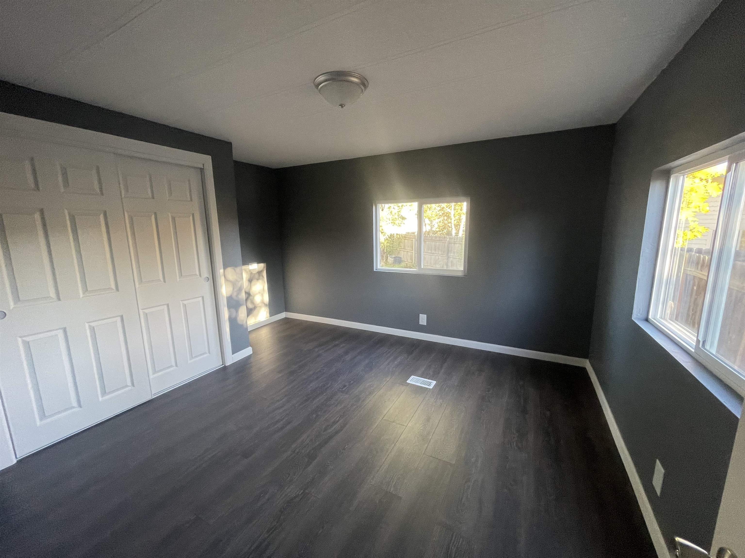 420 Pisces Circle Fruita, CO 81521 - Photo 6 of 12 a view of an empty room with wooden floor and a window