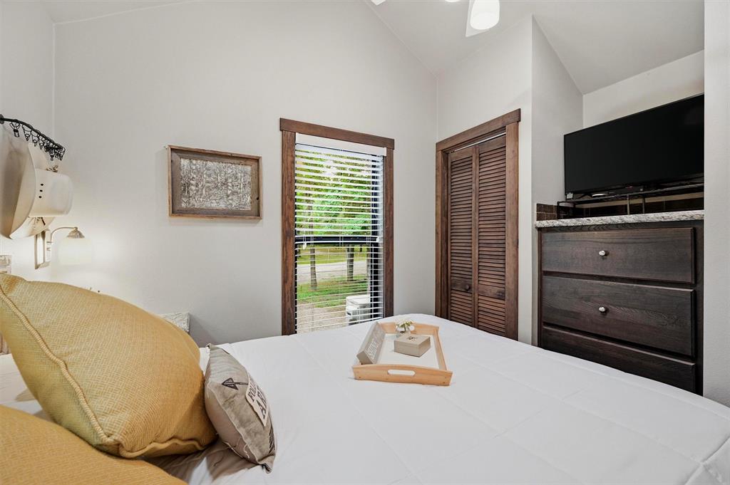 3958 Ranch Road Whitesboro, TX 76273 - Photo 21 of 40 Bedroom with a window featuring horizontal blinds and wood trim