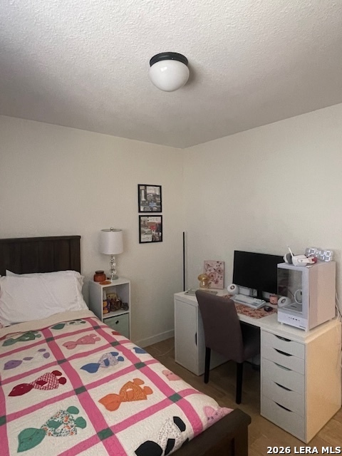 3803 Maverick Crk Road San Antonio, TX 78247 - Photo 11 of 17 a bedroom with a bed and wooden floor