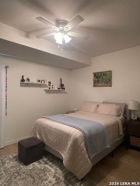 3803 Maverick Crk Road San Antonio, TX 78247 - Photo 12 of 17 a bedroom with a bed and a chandelier