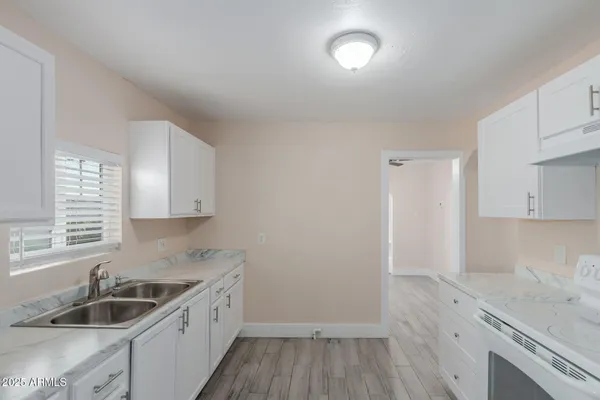 a kitchen that has a sink and a stove