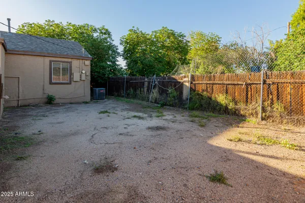 a view of a backyard with wooden fence