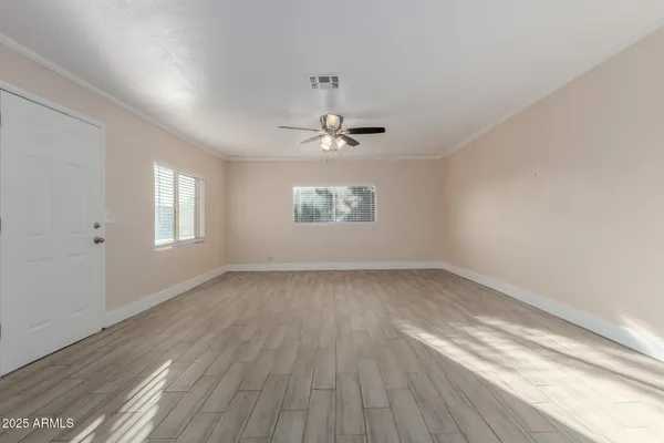 wooden floor in an empty room with a window