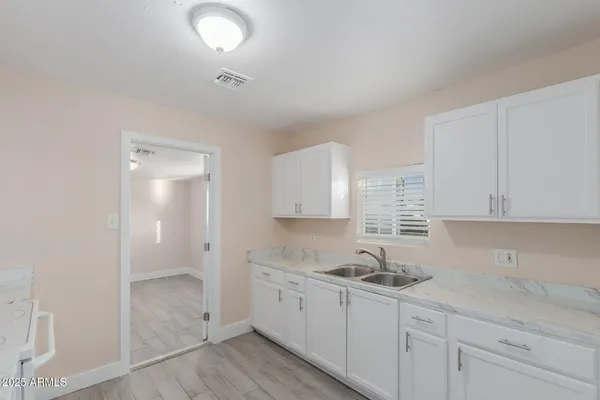 a kitchen with sink and cabinets