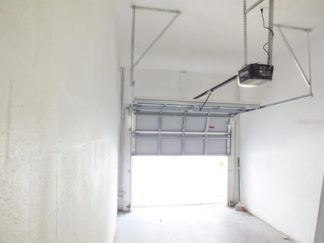 a roof deck with table and chairs and potted plants