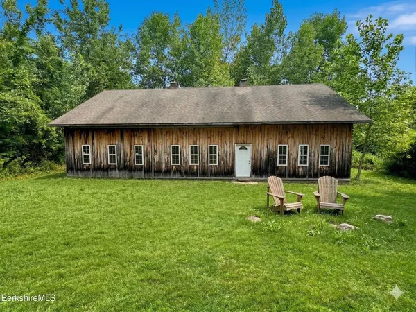 a front view of a house with a yard table and chairs