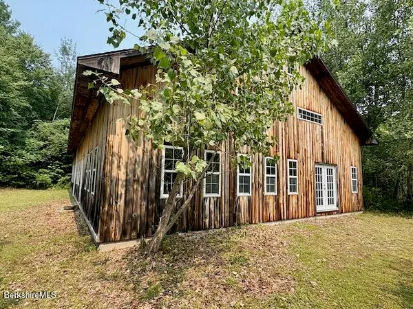 a view of a house with wooden fence