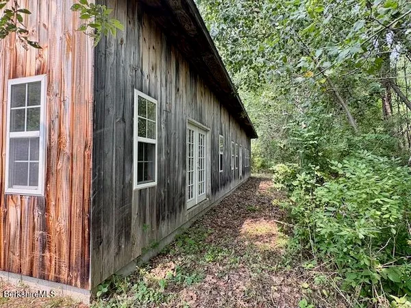a view of backyard of house with green space