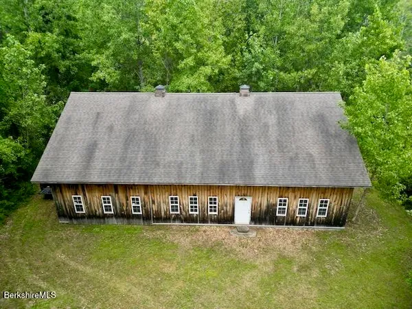 a view of a big yard with large trees