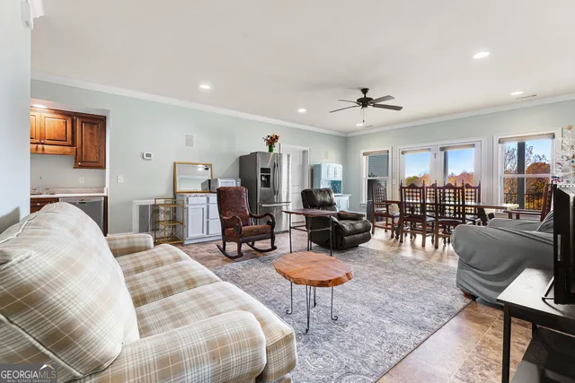 a living room with furniture a table and chairs