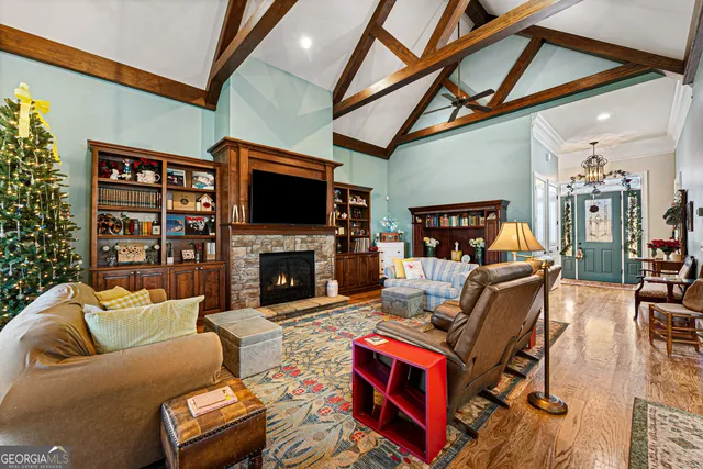 a living room with furniture a flat screen tv and a fireplace