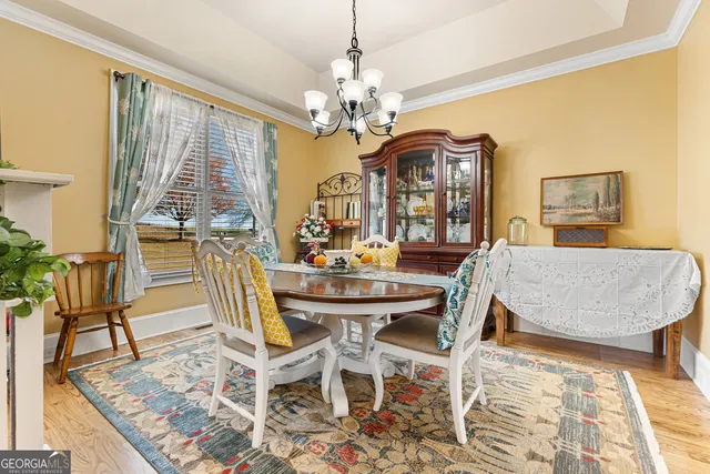 a view of a dining room with furniture and a chandelier