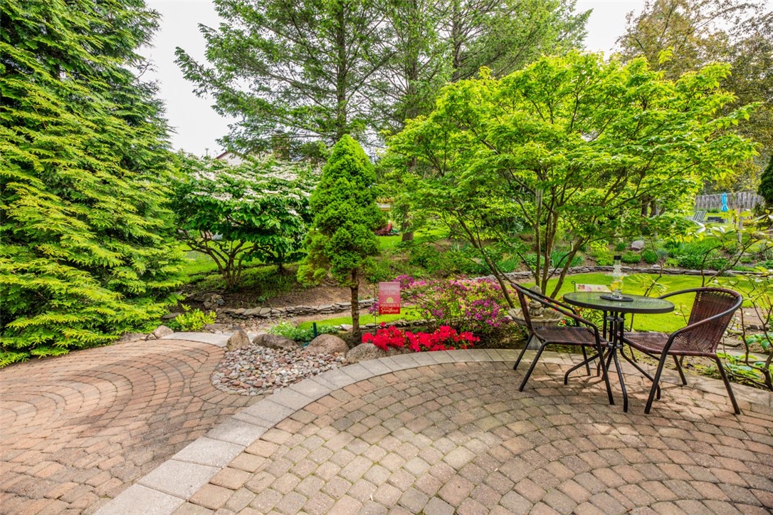 77 Misty Pine Road Perinton, NY 14450 - Photo 47 of 47 THE LUSH PLANTINGS, BOULDERS, STONES, BUSHES, FLOW