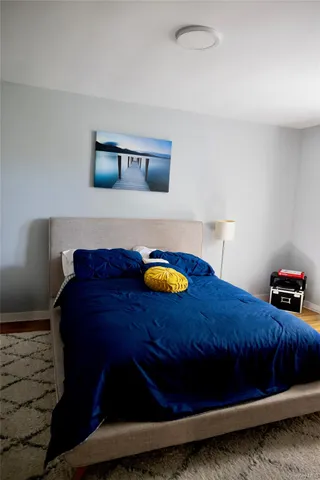 a bed sitting in a bedroom next to a window