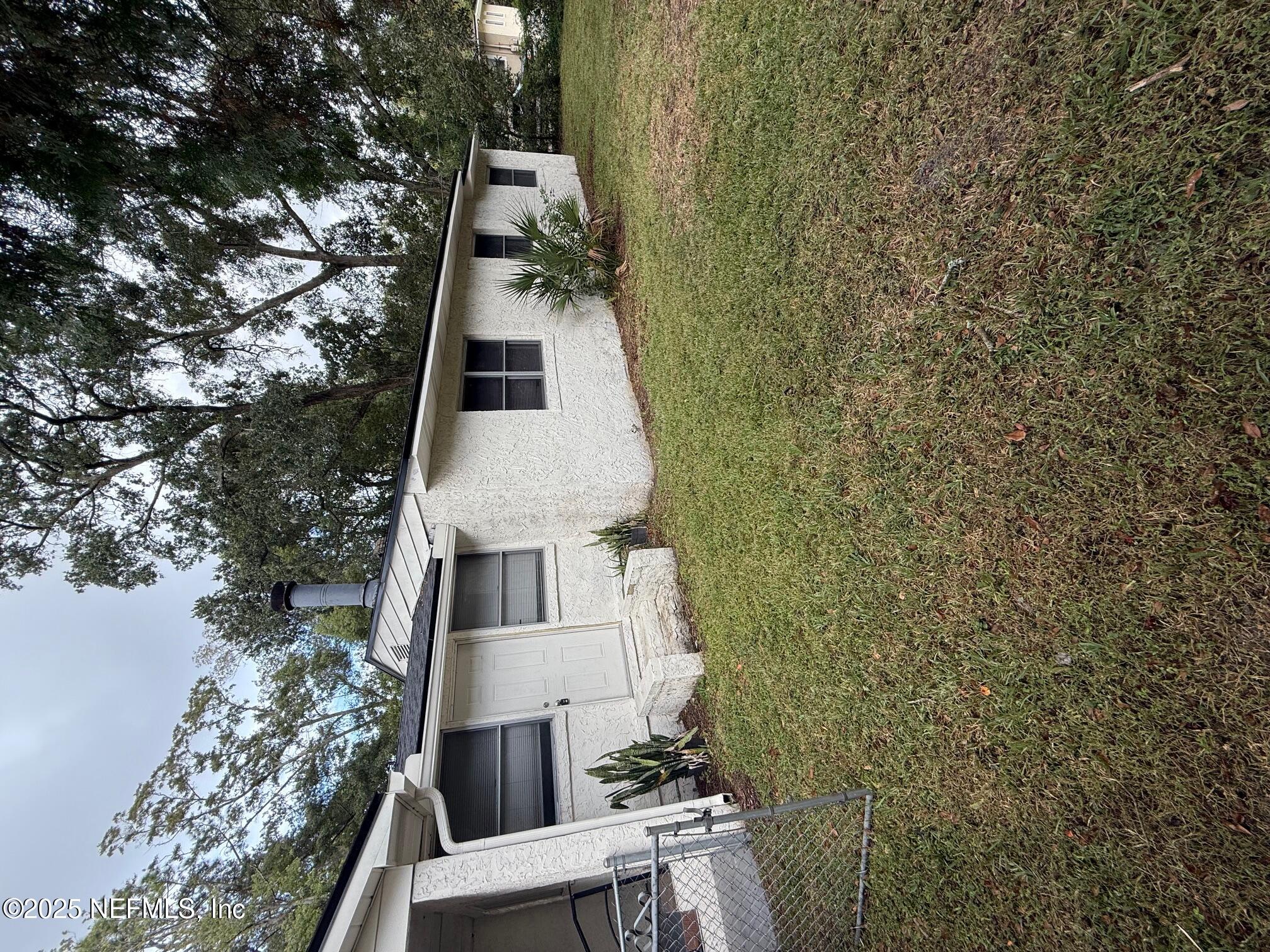 a house that has a tree in front of it