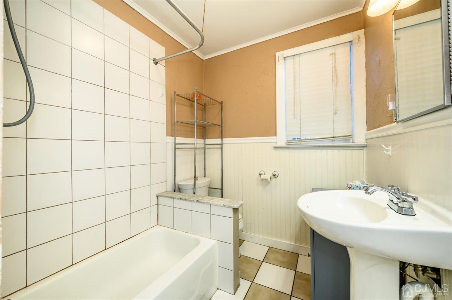 11 Holly Road Brick, NJ 08723 - Photo 18 of 28 a bathroom with a sink and a bathtub