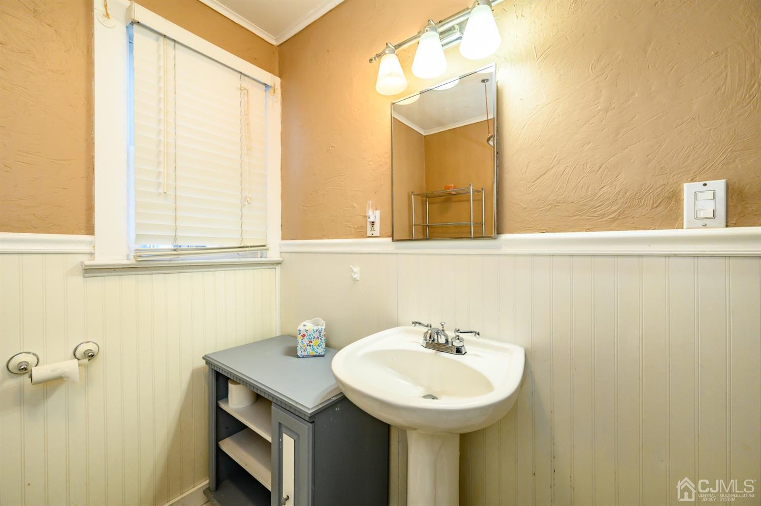 11 Holly Road Brick, NJ 08723 - Photo 19 of 28 a bathroom with a sink and a mirror