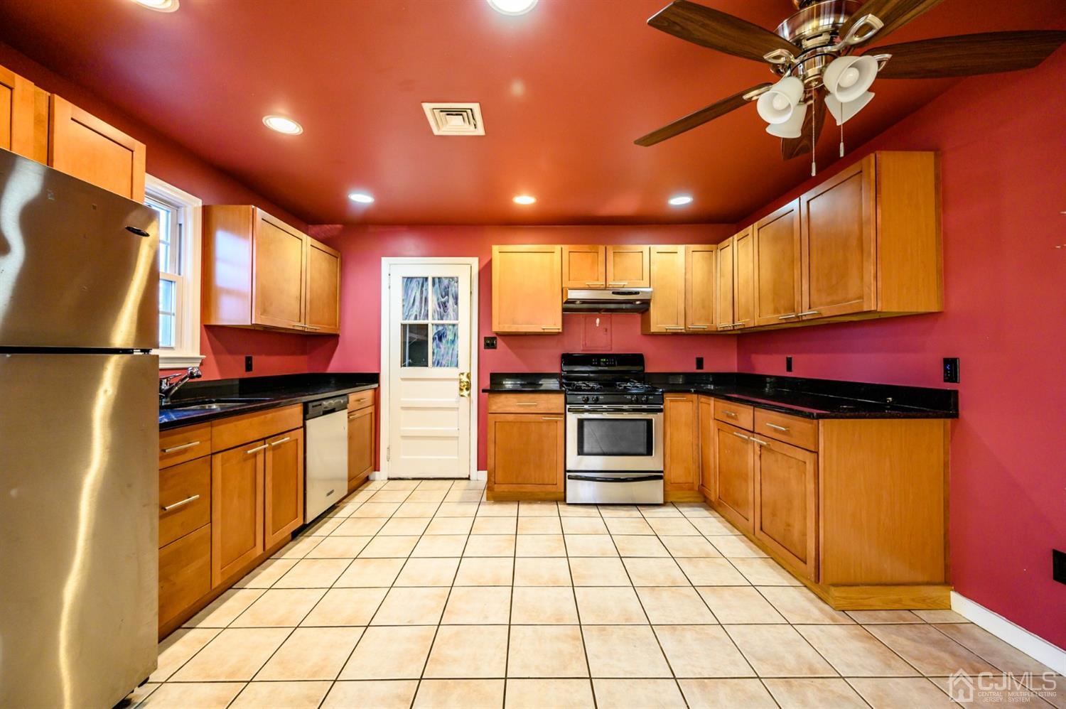 11 Holly Road Brick, NJ 08723 - Photo 3 of 28 a kitchen with stainless steel appliances granite countertop a stove a sink and a microwave