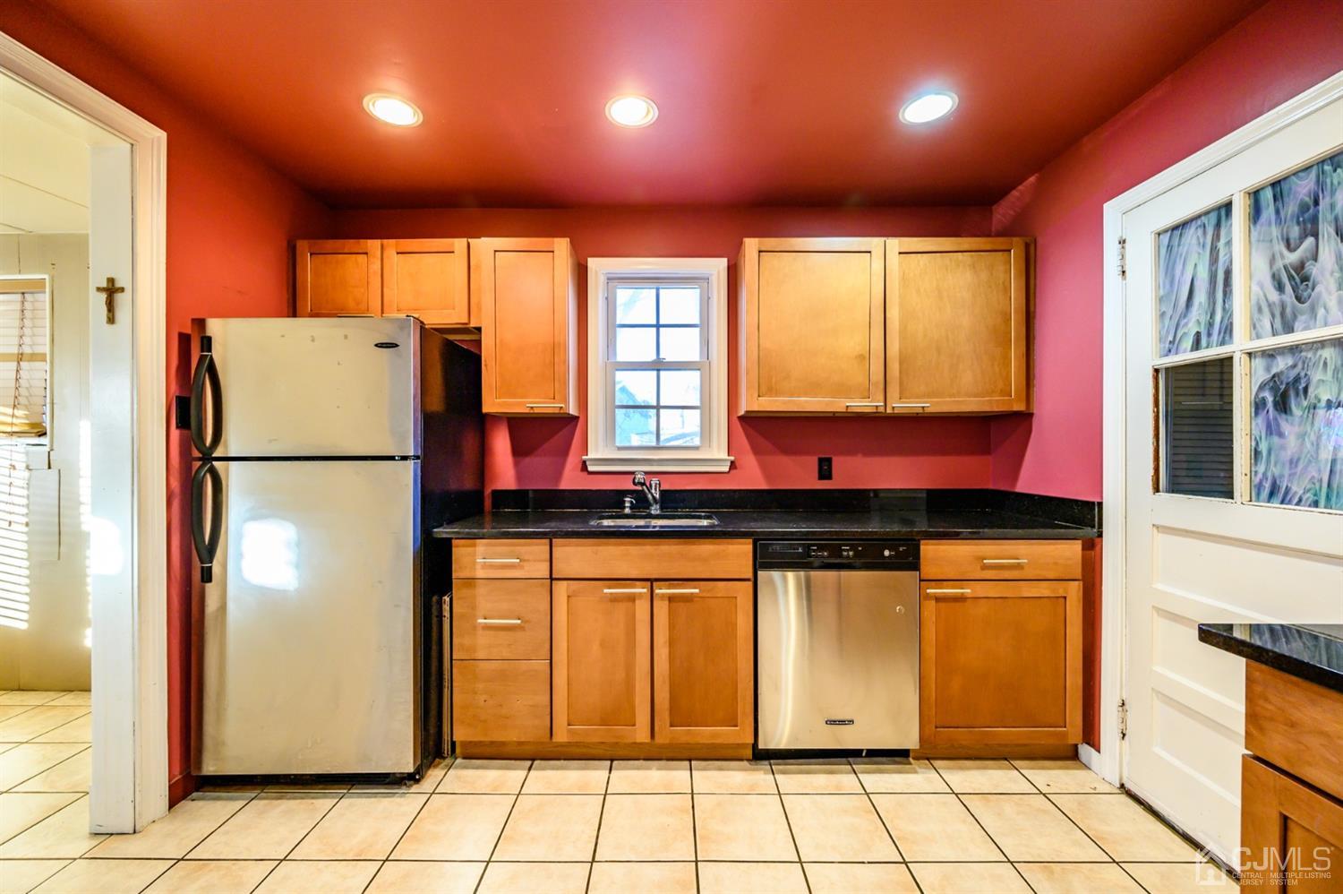 11 Holly Road Brick, NJ 08723 - Photo 4 of 28 a kitchen with stainless steel appliances granite countertop a refrigerator a stove a sink and a microwave