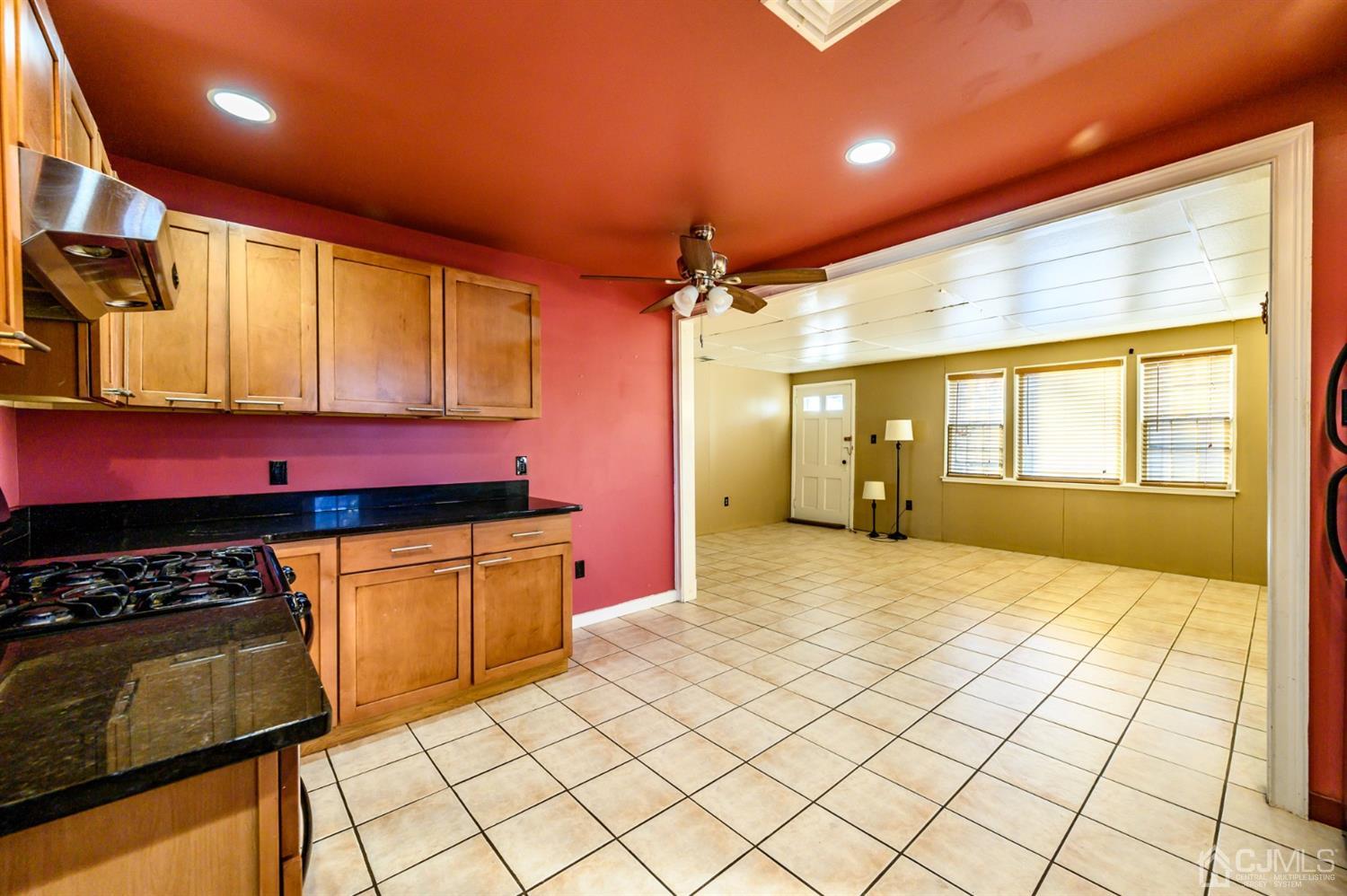 11 Holly Road Brick, NJ 08723 - Photo 5 of 28 a kitchen with stainless steel appliances kitchen island granite countertop a stove a sink and a microwave