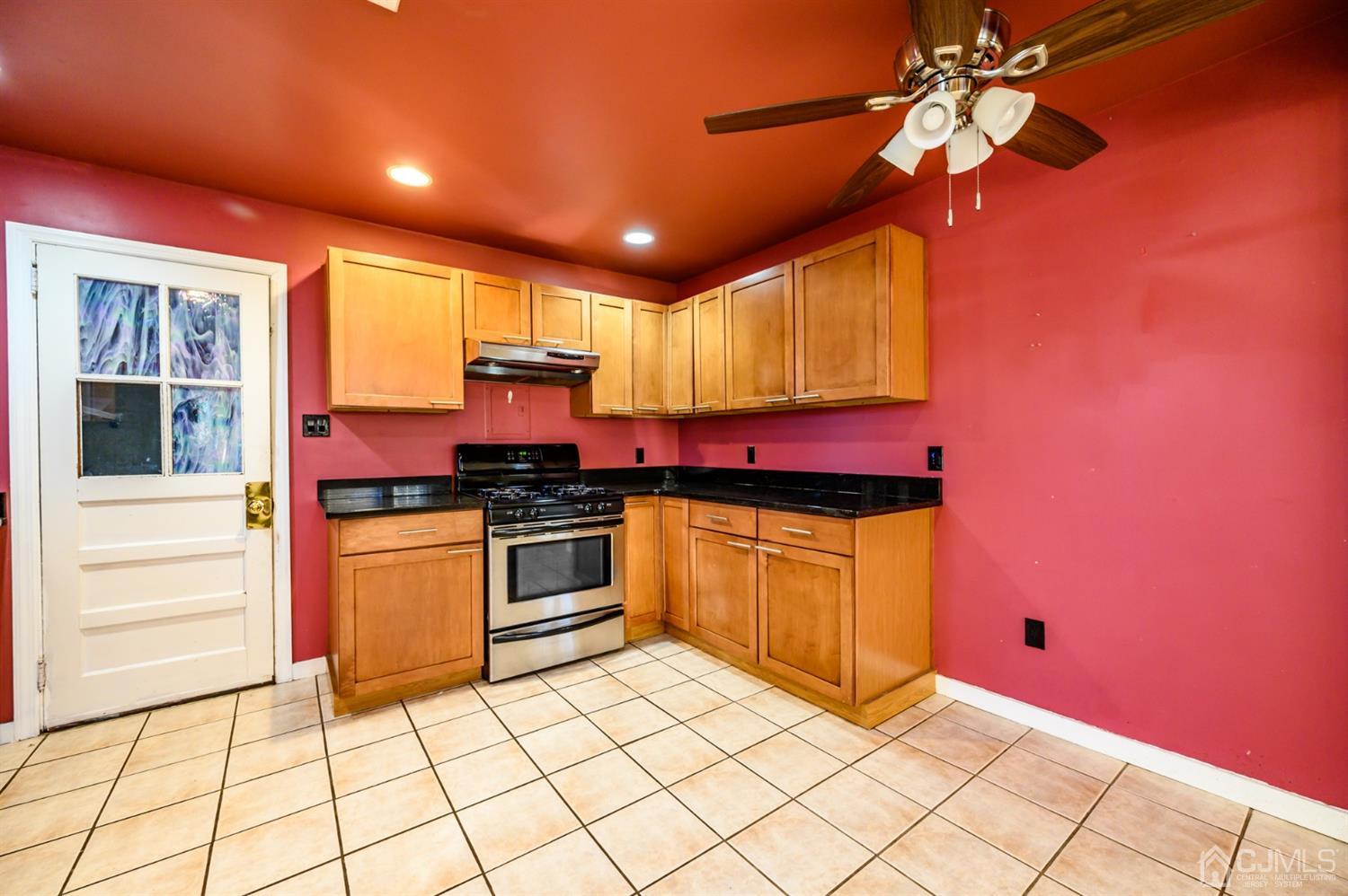 11 Holly Road Brick, NJ 08723 - Photo 6 of 28 a kitchen with stainless steel appliances granite countertop a stove a sink and a microwave
