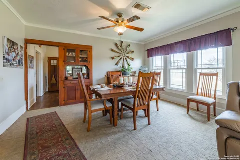 a dining room with furniture a chandelier and a rug
