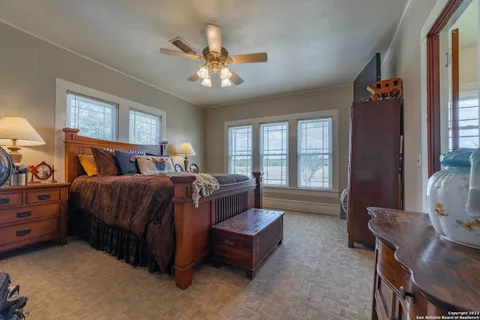 a bedroom with a large bed and a chandelier