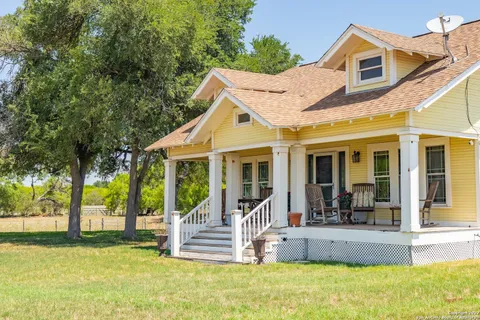a view of a house with a fountain and a yard