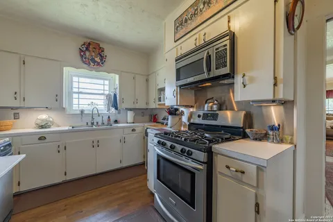 a kitchen with stainless steel appliances granite countertop a stove and a microwave