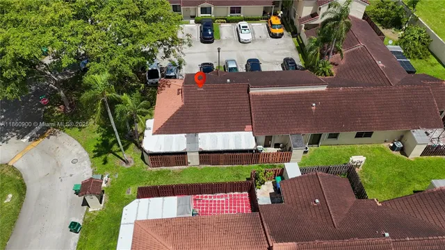 an aerial view of a house with yard