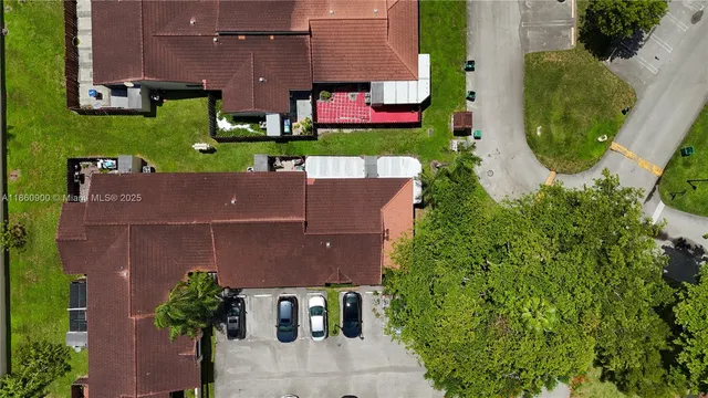 an aerial view of a house with outdoor seating
