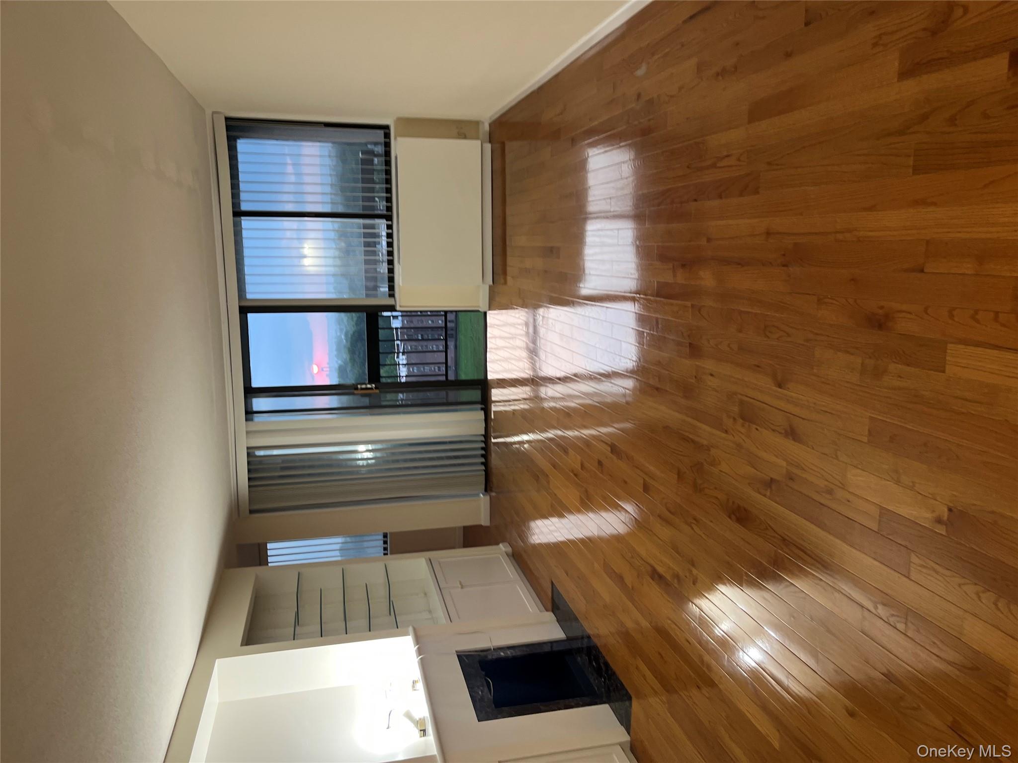 2 Bay Club Drive, Unit 16N Queens, NY 11360 - Photo 3 of 16 Unfurnished living room with a fireplace with flush hearth and hardwood / wood-style flooring