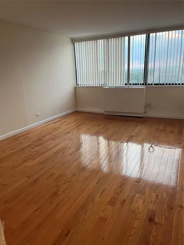a view of wooden floor and windows in a room