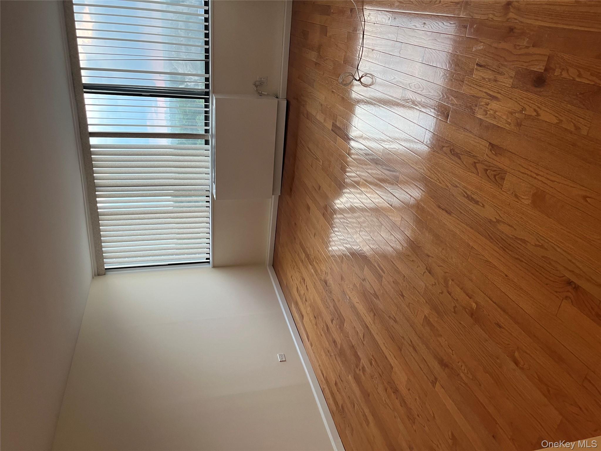 2 Bay Club Drive, Unit 16N Queens, NY 11360 - Photo 4 of 16 Unfurnished room featuring plenty of natural light and wood-type flooring