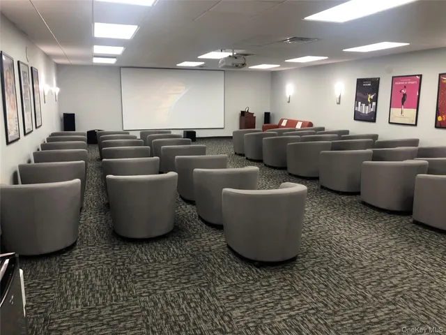 a room with lots of chairs and mirrors