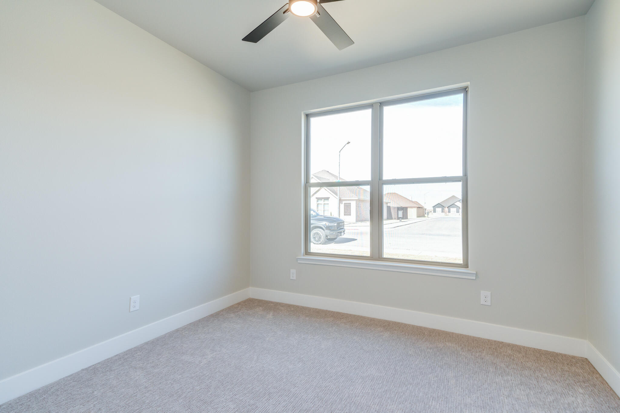 7805 54th Street Lubbock, TX 79407 - Photo 11 of 55 an empty room with a window and a ceiling fan