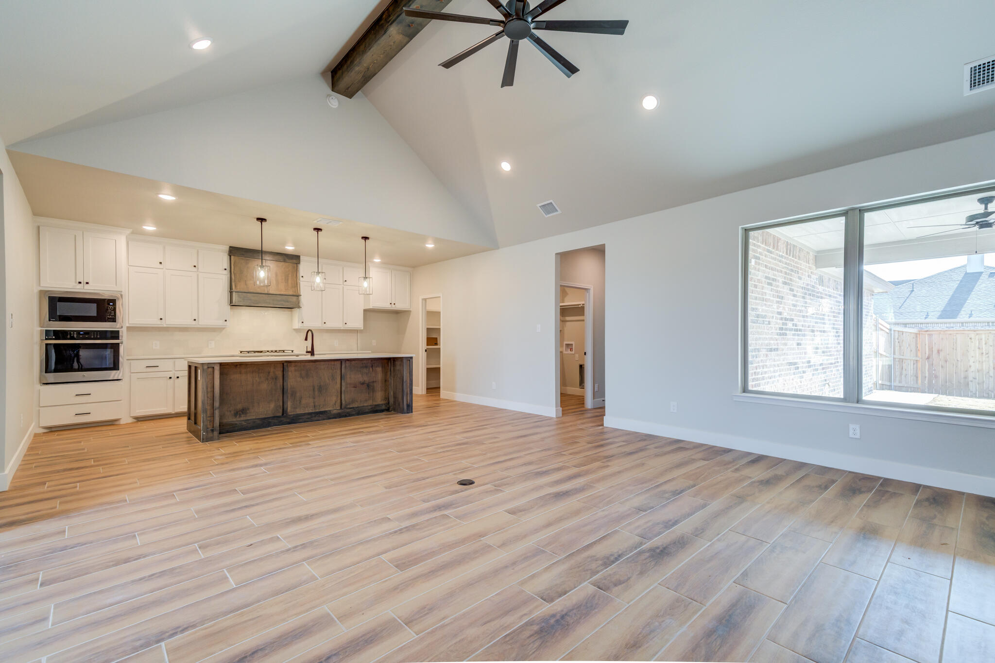 7805 54th Street Lubbock, TX 79407 - Photo 14 of 55 a large kitchen with stainless steel appliances kitchen island a large counter top a sink and a window