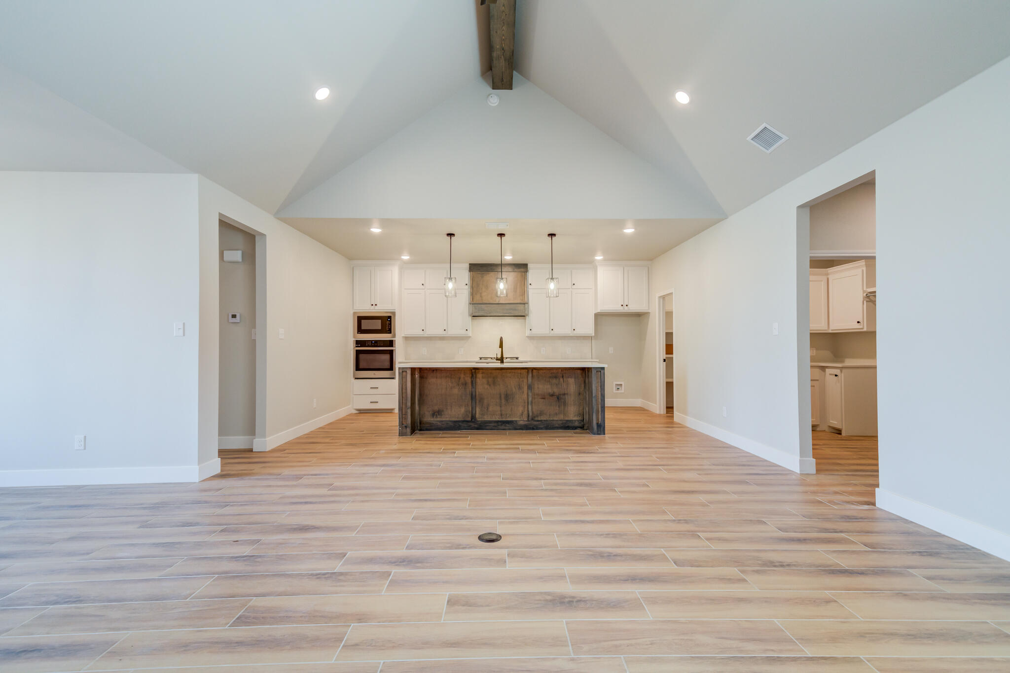 7805 54th Street Lubbock, TX 79407 - Photo 15 of 55 a view of kitchen with kitchen island wooden floor center island and stainless steel appliances