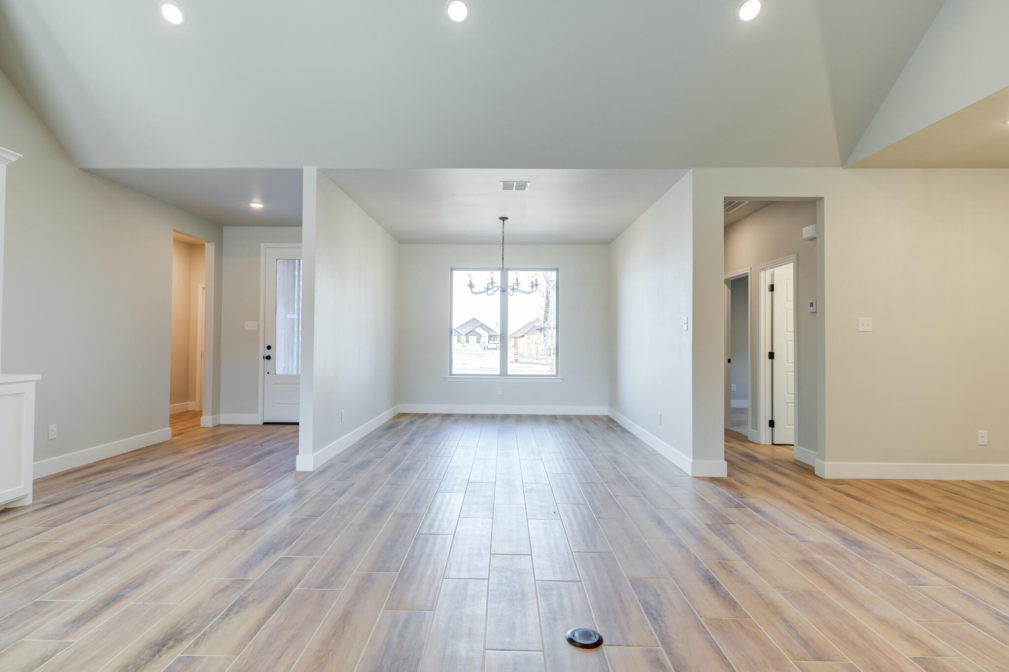 7805 54th Street Lubbock, TX 79407 - Photo 18 of 55 an empty room with wooden floor and windows