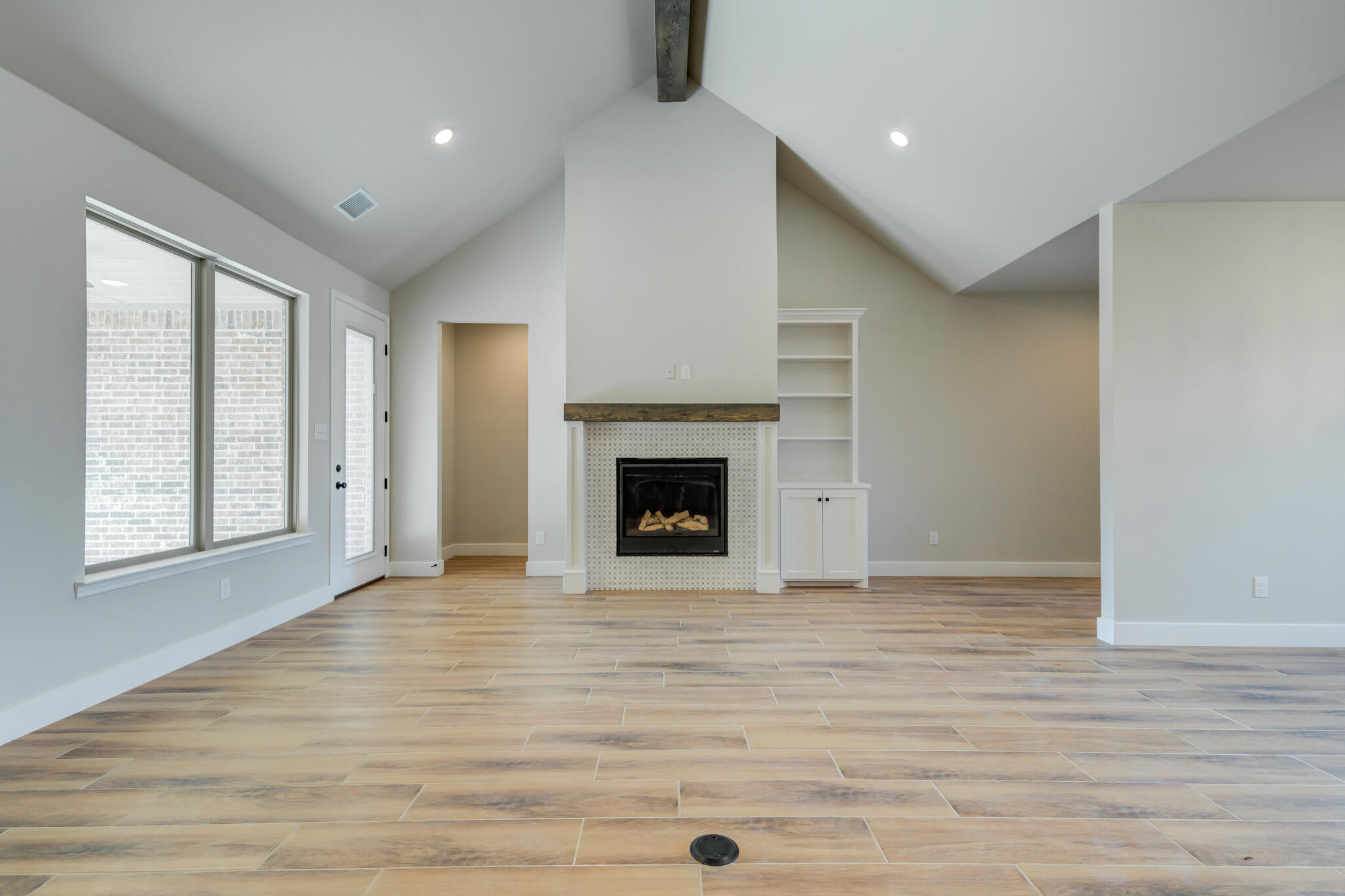 7805 54th Street Lubbock, TX 79407 - Photo 20 of 55 a view of an empty room with a window and fireplace