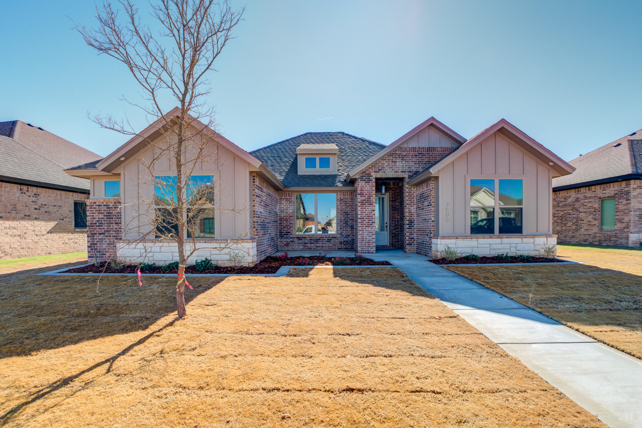 7805 54th Street Lubbock, TX 79407 - Photo 2 of 55 a front view of house with yard and trees around