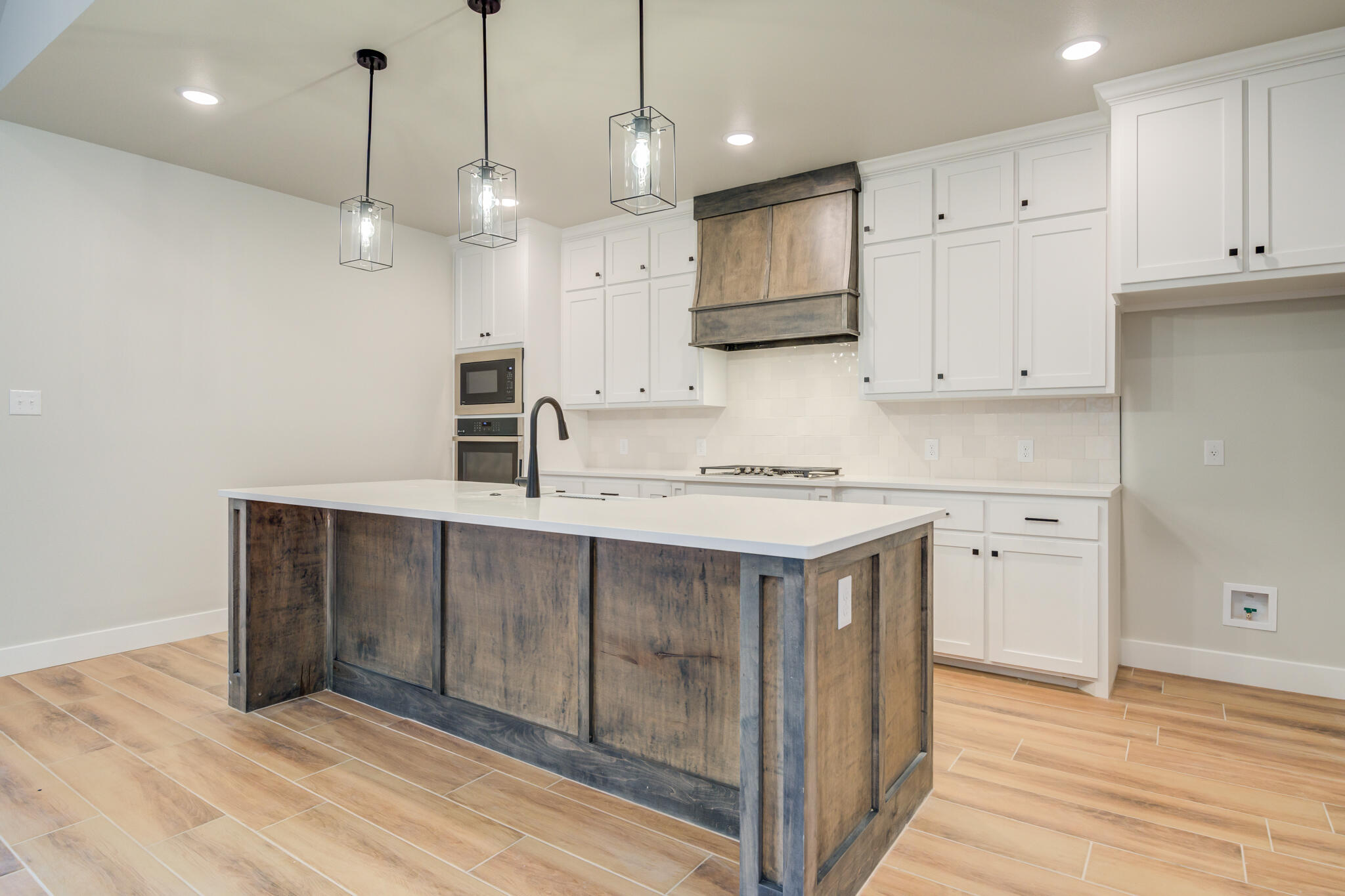 7805 54th Street Lubbock, TX 79407 - Photo 25 of 55 a kitchen with kitchen island a sink stainless steel appliances and cabinets