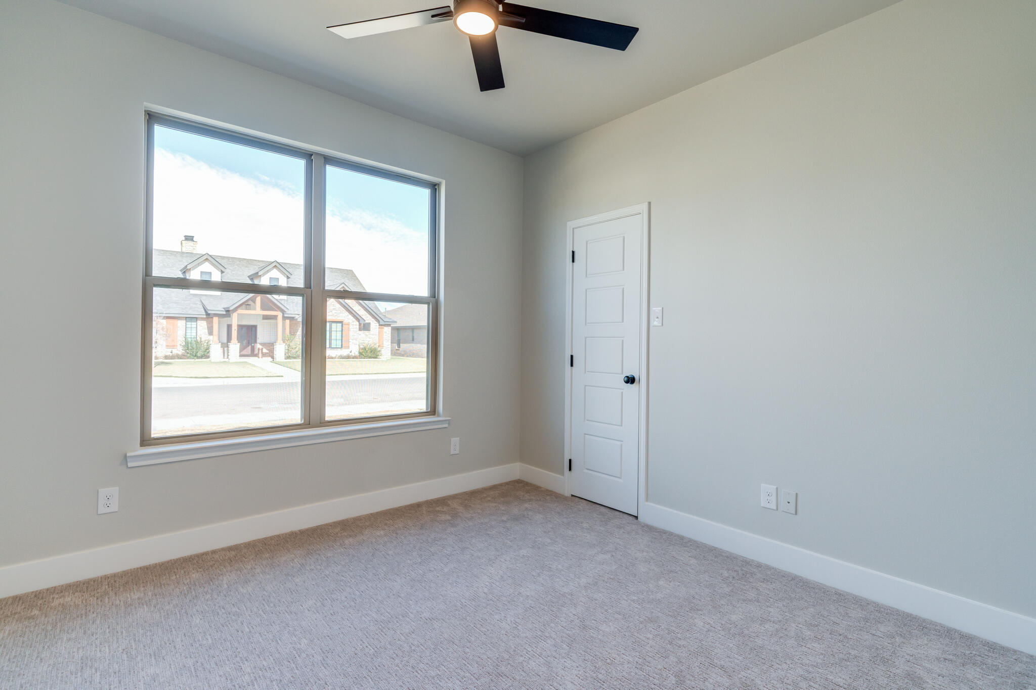7805 54th Street Lubbock, TX 79407 - Photo 36 of 55 an empty room with a window and a ceiling fan