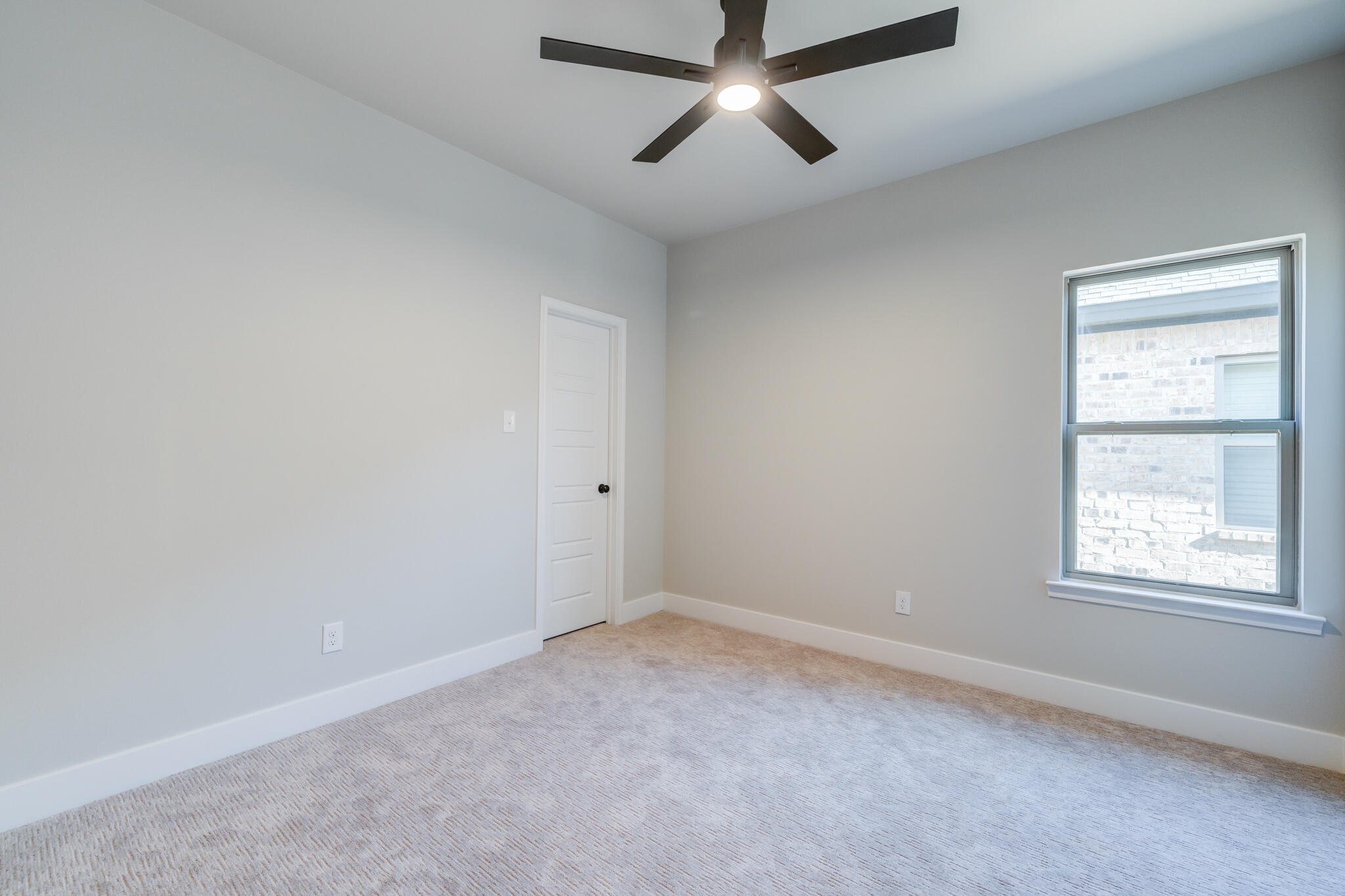 7805 54th Street Lubbock, TX 79407 - Photo 38 of 55 an empty room with a window and a fan