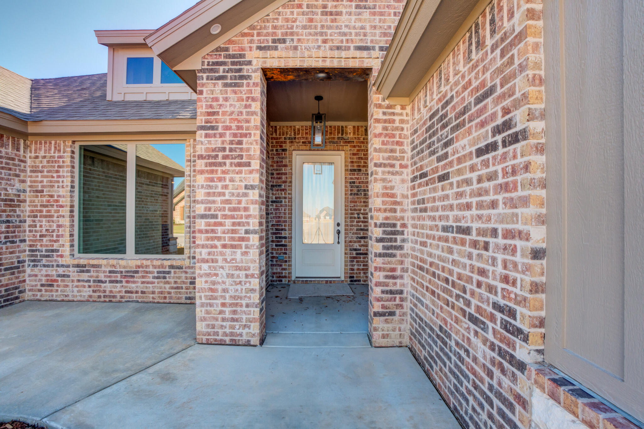 7805 54th Street Lubbock, TX 79407 - Photo 4 of 55 front view of a brick house with a door
