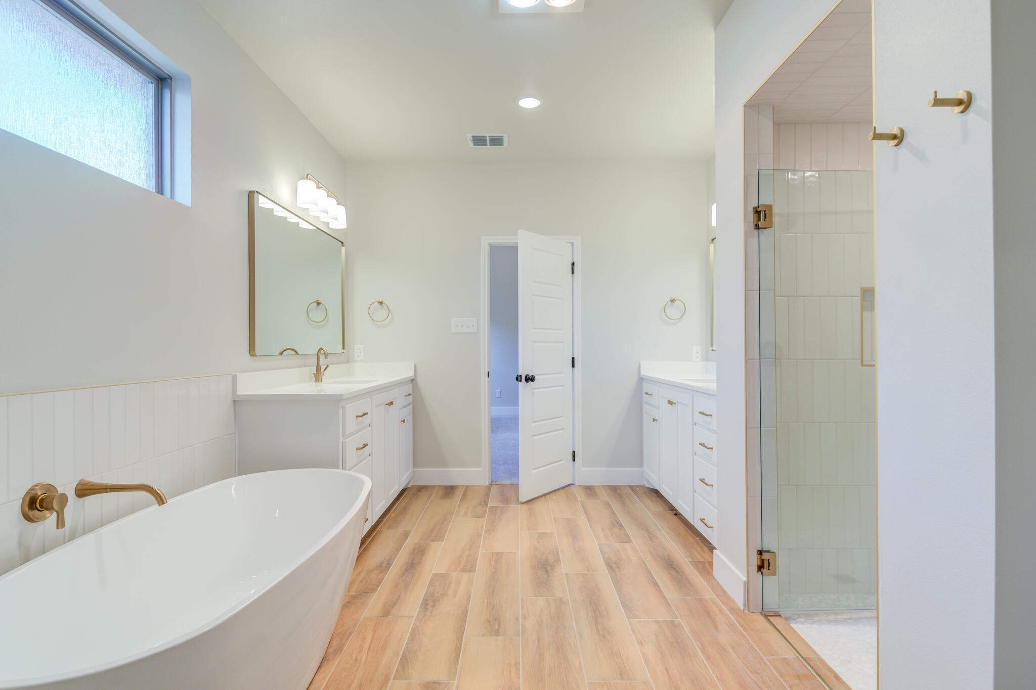 7805 54th Street Lubbock, TX 79407 - Photo 52 of 55 a spacious bathroom with a tub sink and mirror