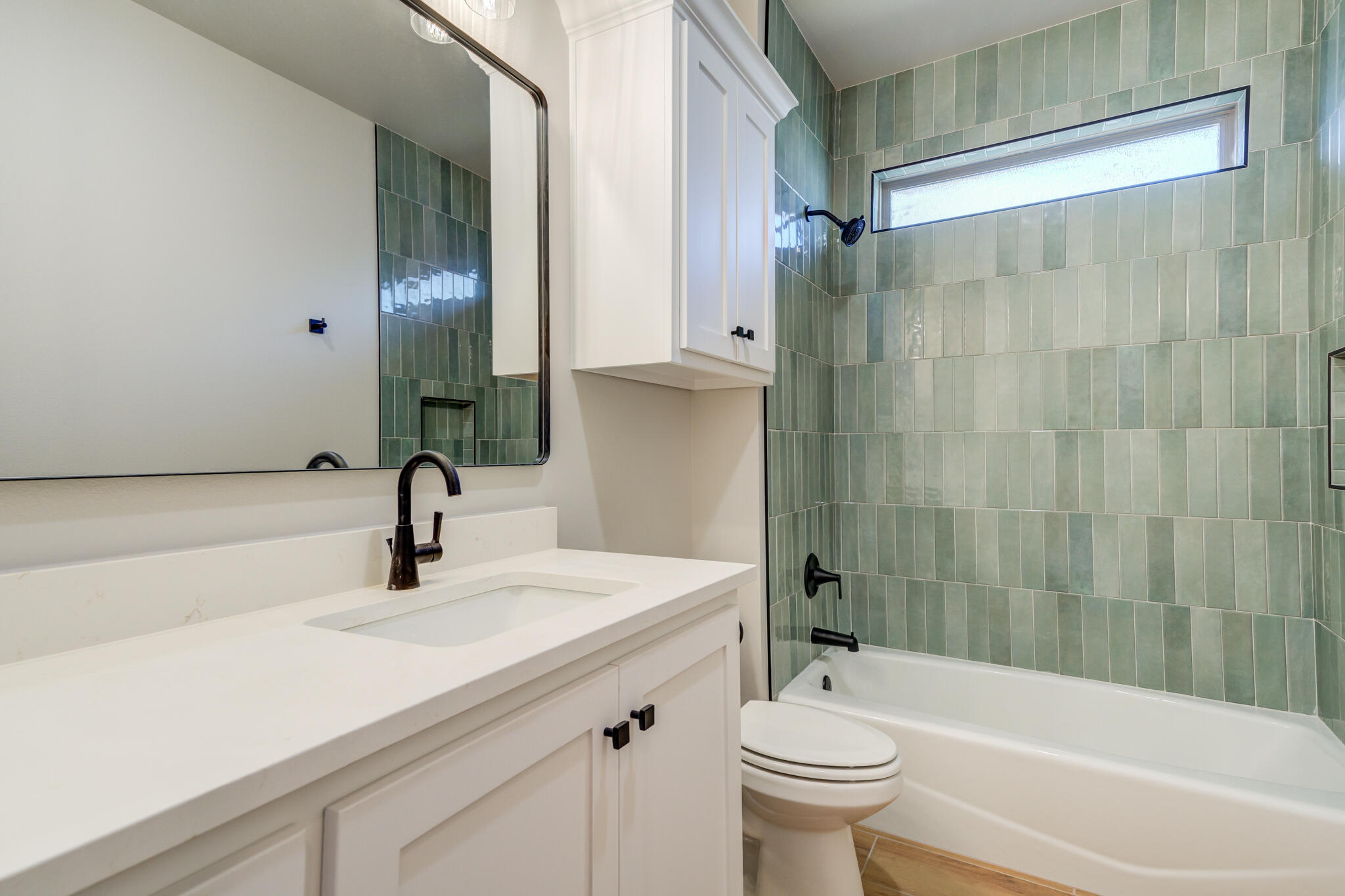 7805 54th Street Lubbock, TX 79407 - Photo 10 of 55 a bathroom with a sink a toilet and a bathtub