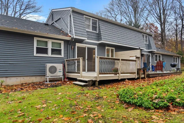a backyard of a house with yard table and chairs