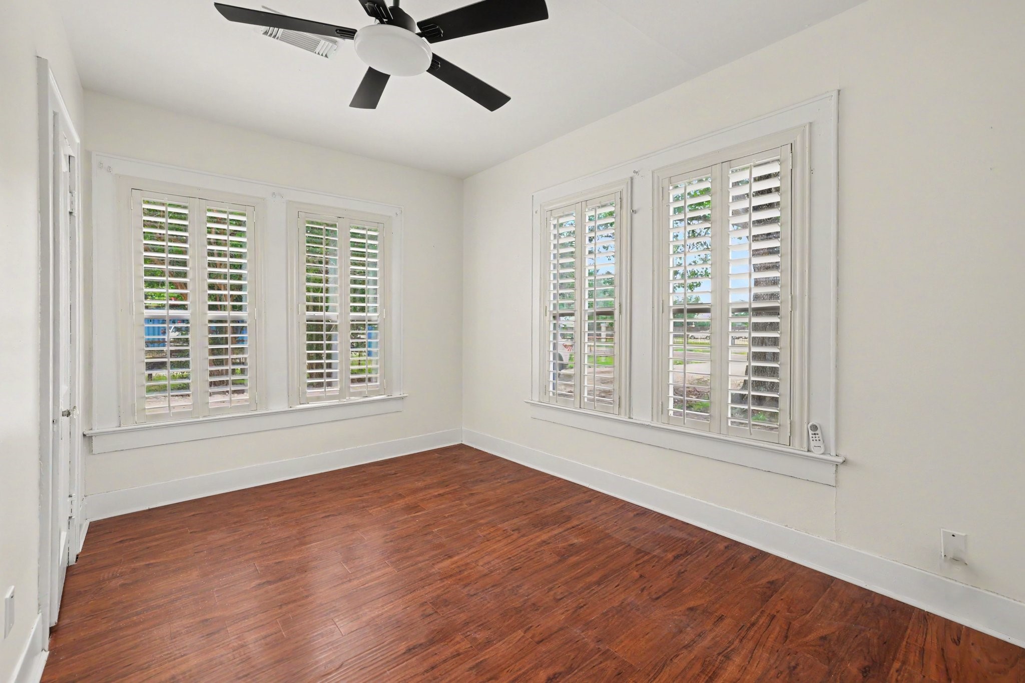 31730 Waller Tomball Road Waller, TX 77484 - Photo 30 of 50 This bedroom features large windows with white plantation shutters for ample natural light.